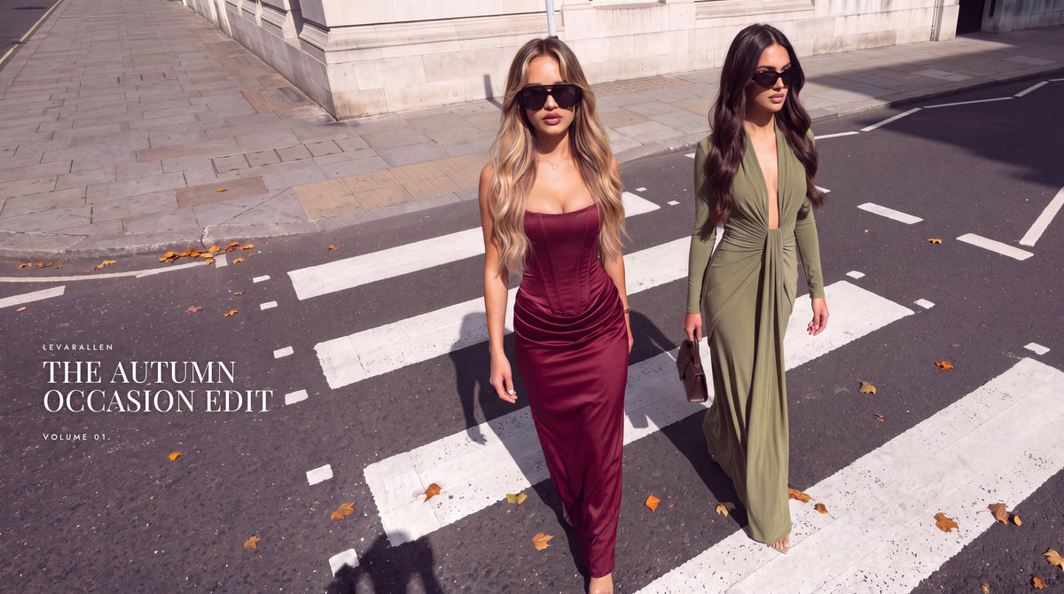 The Autumn Occasion Edit by Levarallen: two women crossing a city street in a wine red satin corset maxi dress and an olive green V-neck maxi dress