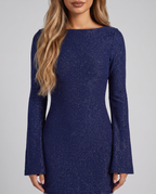 Women's navy sparkly backless bodycon mini dress with a boat neck and long sleeves, close-up of the boat neckline and sparkly finish