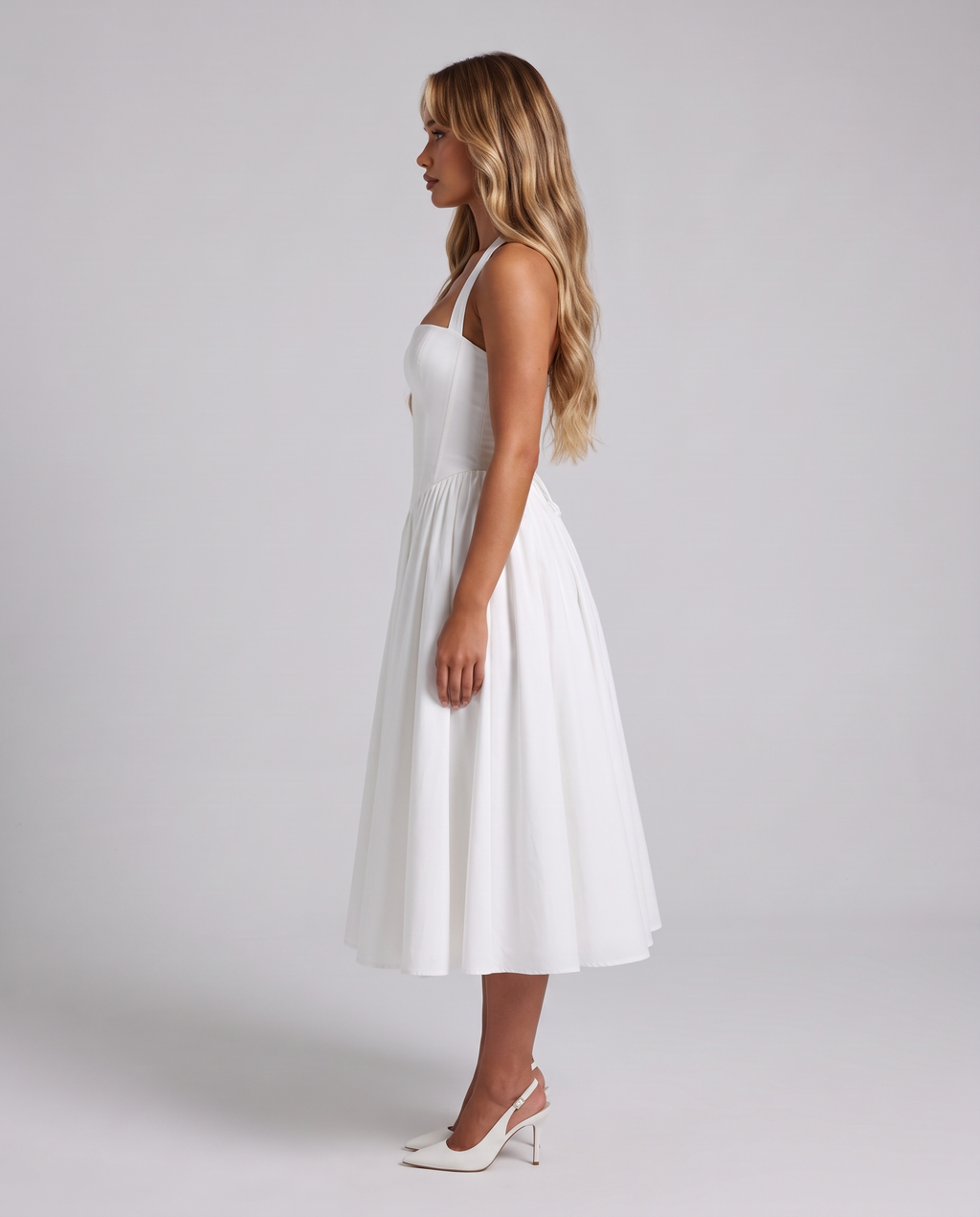 Women's white halter neck corset midi dress with a square neckline and full skirt, side view