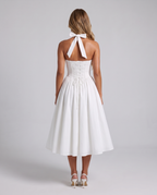Women's white halter neck corset midi dress with a square neckline and full skirt, back view