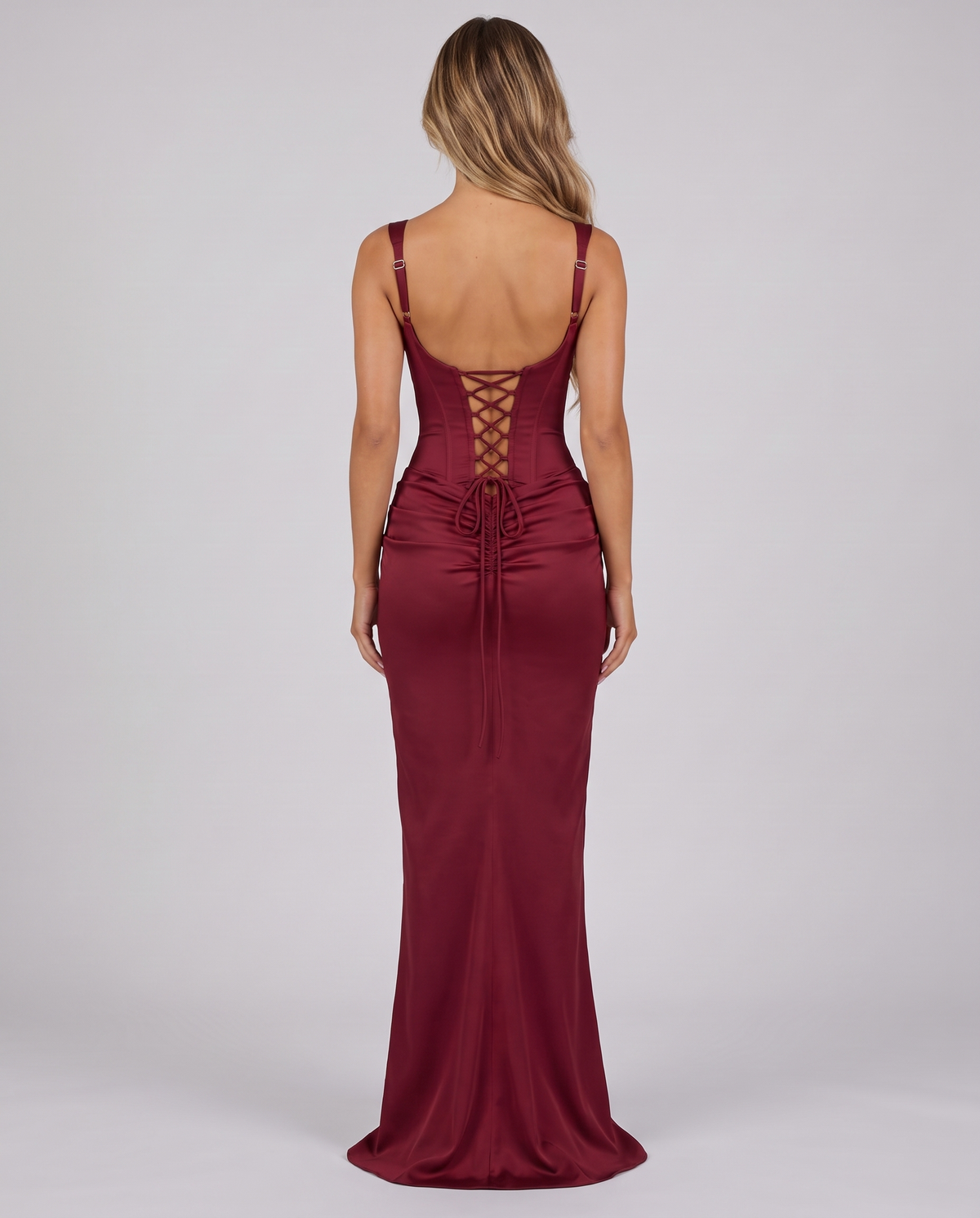 Women's wine red corset maxi dress with a square neck, draped hip and lace-up back, back view