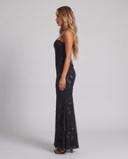 Women's black floral embroidered corset maxi dress with a fishtail skirt, side view