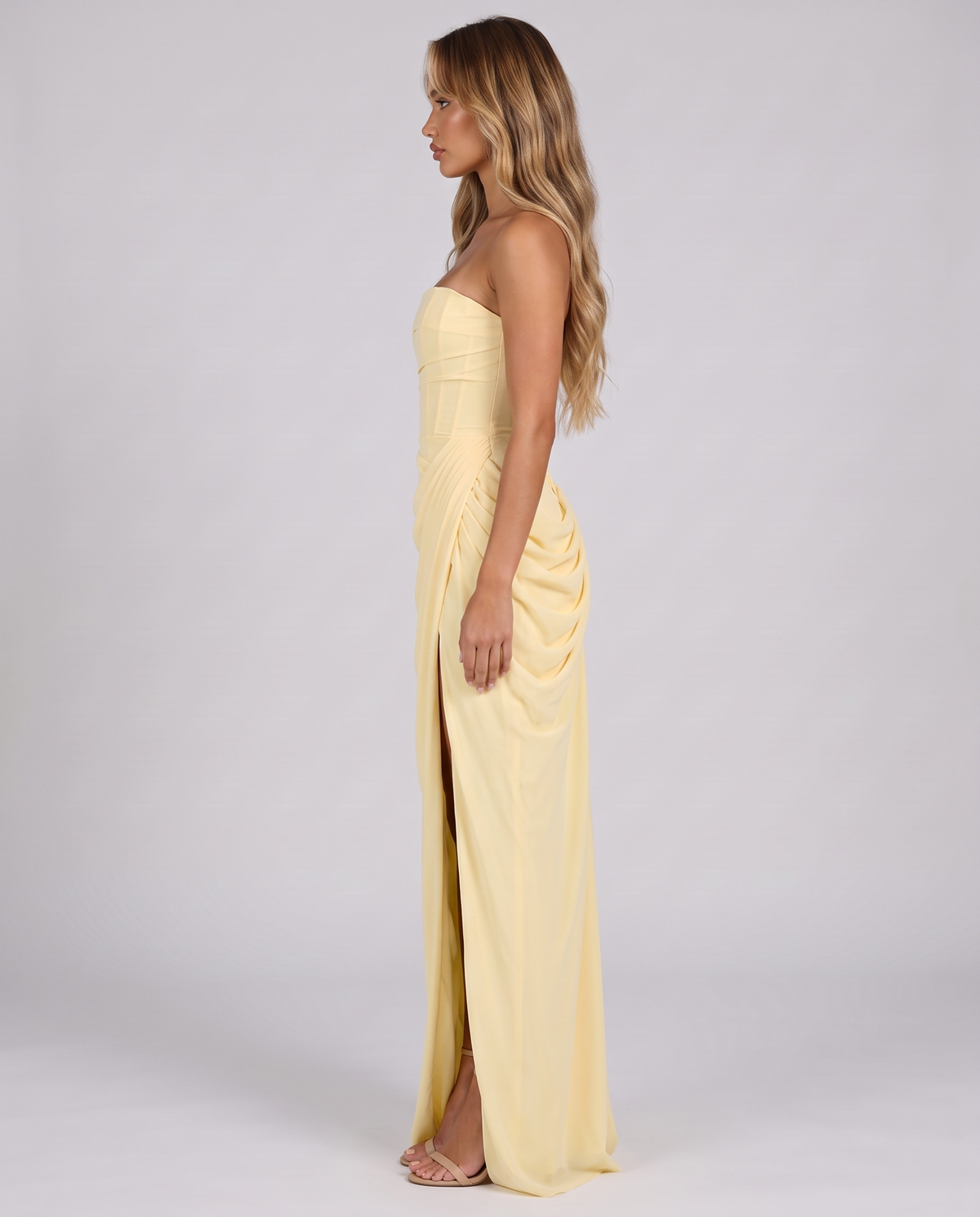 Women's lemon corset maxi dress, strapless with a draped skirt and high slit, side view