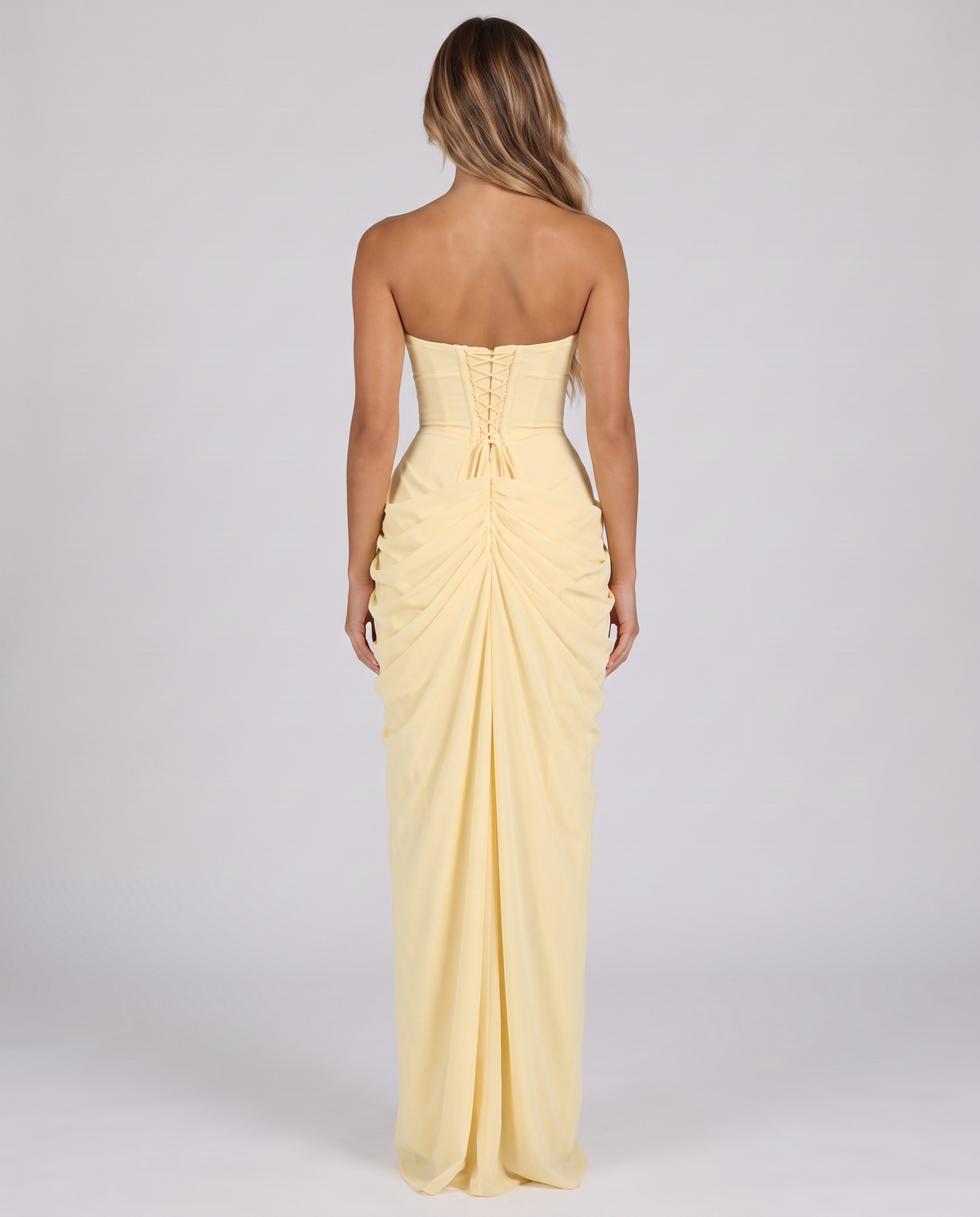 Women's lemon corset maxi dress, strapless with a draped skirt and high slit, back view