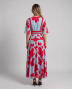 Women's light blue floral maxi dress with a V-neck wrap bodice and red trim, back view