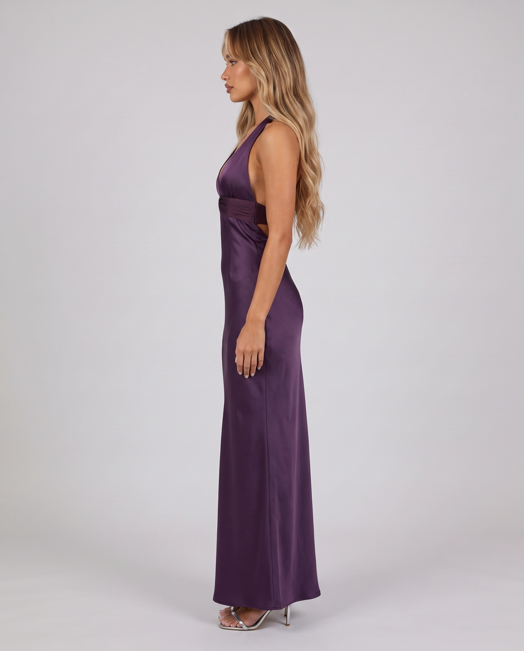 Women's deep purple halter neck maxi dress with a plunge V-neck and open back, side view
