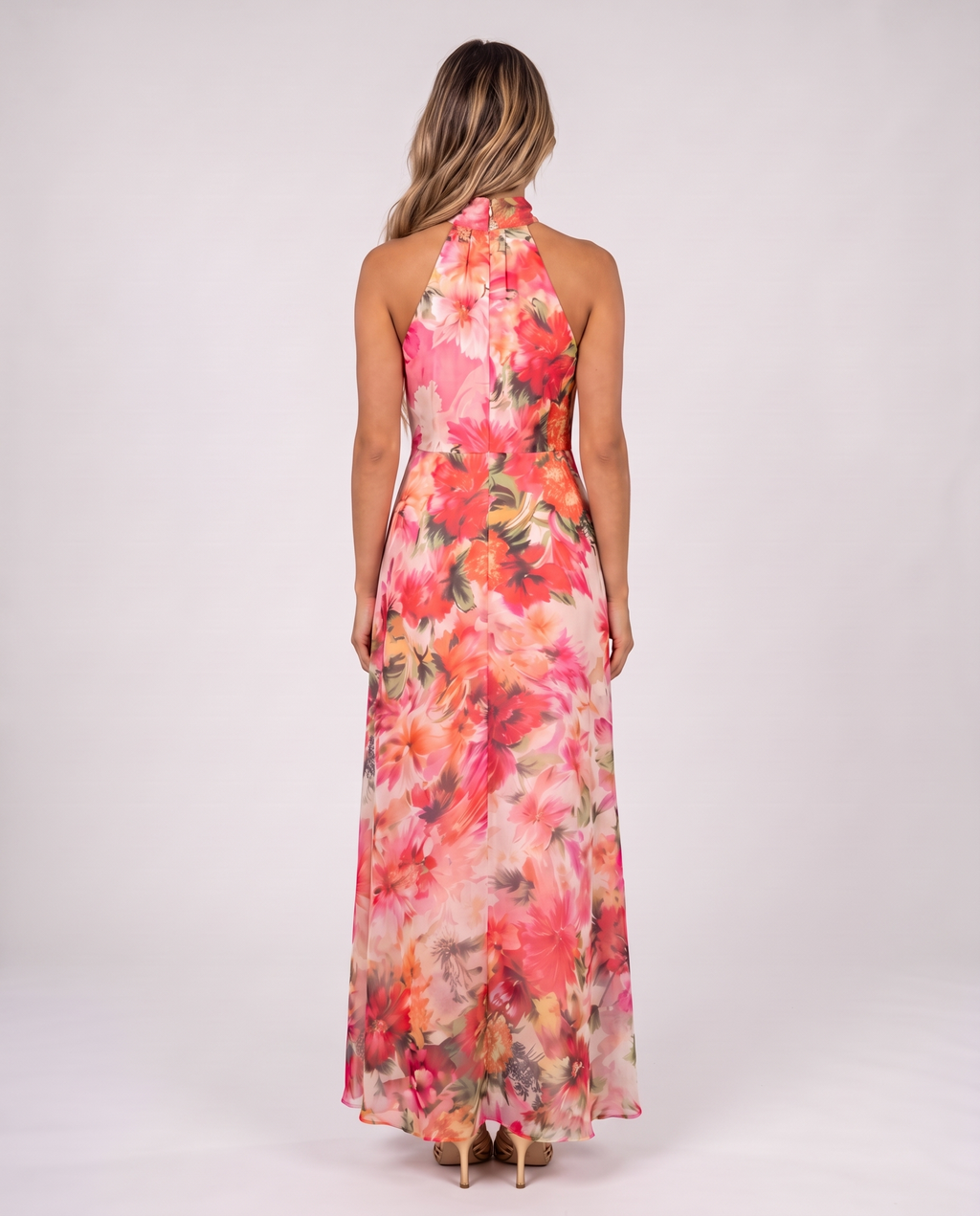 Women's coral pink floral halter neck maxi dress with a floaty A-line skirt, back view