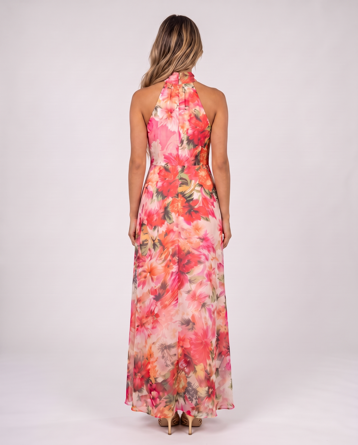Women's coral pink floral halter neck maxi dress with a floaty A-line skirt, back view