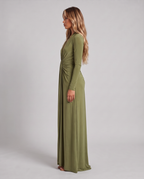 Women's olive green long sleeve maxi dress with a plunge V-neck and open back, side view