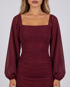 Women's wine red sparkly bodycon mini dress with a square neck and sheer balloon sleeves, close-up of the square neckline and sheer balloon sleeves