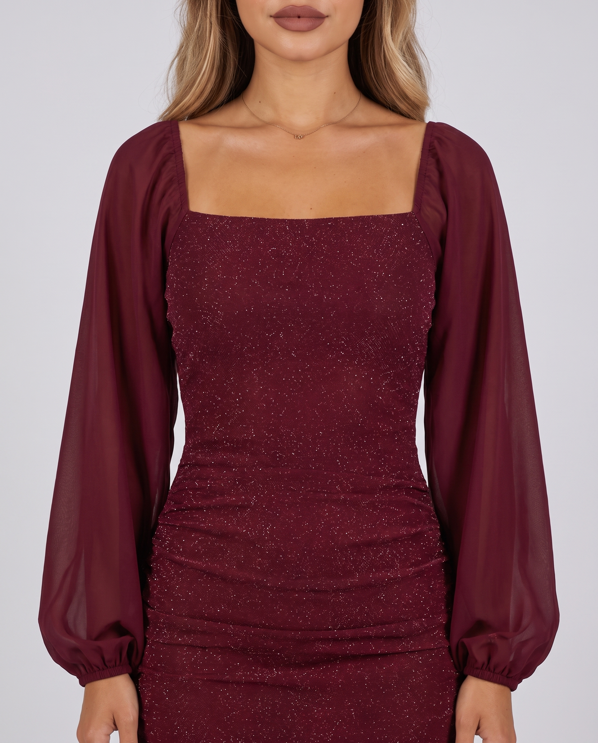 Women's wine red sparkly bodycon mini dress with a square neck and sheer balloon sleeves, close-up of the square neckline and sheer balloon sleeves
